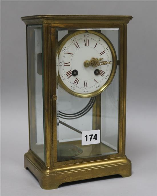 A late 19th century French brass four glass mantel clock